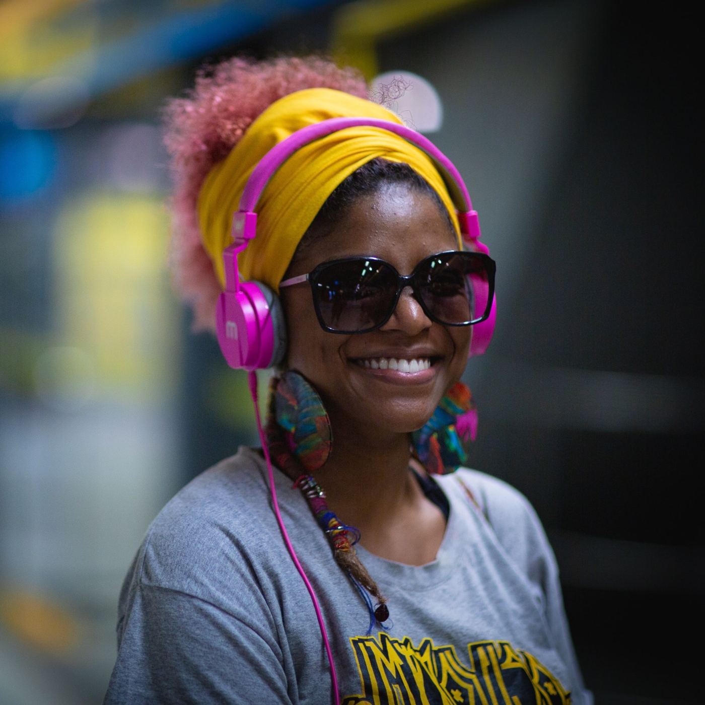 Smiling listener wearing pink headphones