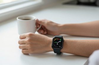 person checking smartwatch health data at kitchen table