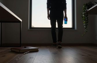 Person contemplating smartphone use in a home office