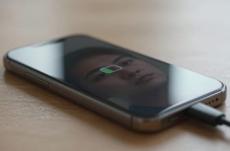 person charging smartphone in modern home