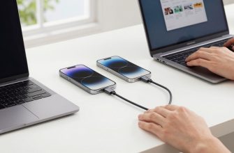 USB-C cable connecting laptop, phone, and tablet on a desk