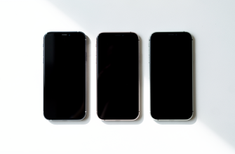 Three budget smartphones on a white surface