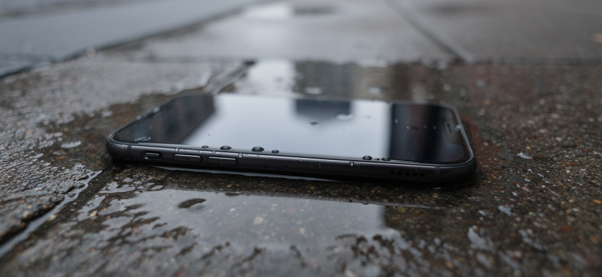 Smartphone in a puddle after rain
